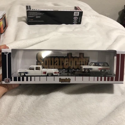 M2 MACHINES 76 GMC SIERRA 3500 DUALLY & 75 GMC JIMMY SIERRA SQUAREBODY SYNDICATE - Image 1 of 3