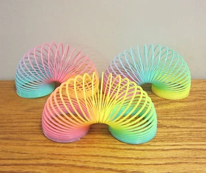 3 NEW MAGIC GLOW IN THE DARK COIL SPRINGS MULTI COLORED 3" PLASTIC COIL SPRING - Picture 1 of 4