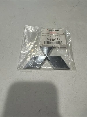 New Mitsubishi 7415A111 2008-17 Lancer 2020-24 Outlander Sport Rear Emblem Badge - Image 1 of 3