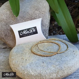 Juego de dos pulseras elásticas rellenas de oro amarillo de 14K. - Imagen 1 de 5