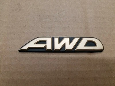 Subaru OEM 2000-2003 Outback Limited "AWD" Gold Rear Trunk Lid Emblem Logo Badge - Image 1 of 2
