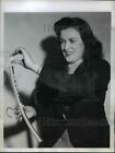 1946 Press Photo Lillian Nelson inserts a standard moth ball in clothes hanger
