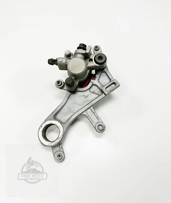 2007 05-17 HONDA CRF250R CRF 250R OEM NISIN REAR BACK BRAKE CALIPER HANGER GOOD - Image 1 of 4
