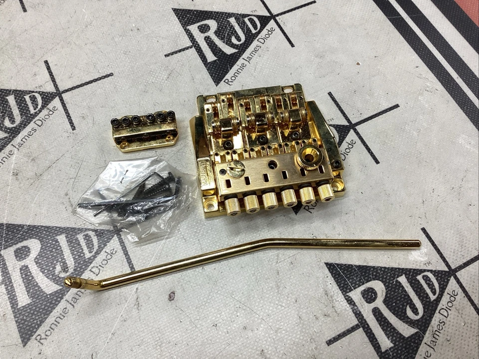 Washburn Shift Wonderbar Trémolo Puente Vibrato Dorado Años 80 Nuevo de Lote Antiguo Foto 1 de 4