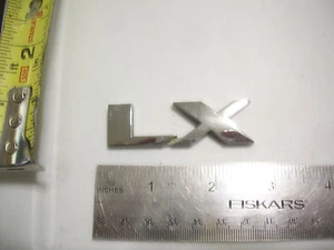 LX LETRAS EMBLEMA BOLSA CROMO OEM ORIGINAL - Imagen 1 de 1