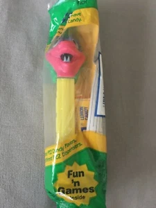 PEZ Dinosaur Candy Dispenser Yellow Stem Pink/Green Head Purple Eyes Green Wrap - Picture 1 of 2