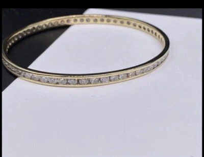 Ladies 10 Karat Gold and Round Brilliant Cut Diamond Eternity Bangle Bracelet  - Image 1 of 4