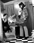 Motique store two customers look closely a shiny raincoat worn- 1931 Old Photo