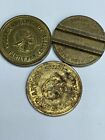 2 OLD GOLFLAND SLOTTED BRASS ARCADE TOKENS AND ONE OTHER (3 PIECES)