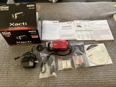 Sanyo Xacti Red VPC-SH1 Dual Camera Photos & Video, Battery & Charger - Image 1 of 4