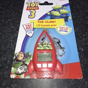 Schlüsselanhänger The Claw LCD Videospiel Toy Story 3 Disney Pixar Keyring 2010 - NEU - Bild 1 von 6
