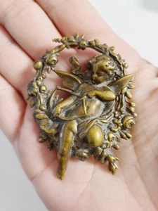 VINTAGE VICTORIAN PIN BROOCH BRASS CUPID ON FLORAL WREATH REPOUSSE CHERUB  - Picture 1 of 15