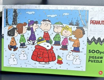 Peanuts Snoopy Holiday 500pc Jigsaw Puzzle- Red Puffer Coat 23.5" x 16.5" Age 9+ - Image 1 of 2