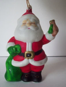 Santa Claus with bag of toys holding ? porcelain Christmas ornament - Picture 1 of 4
