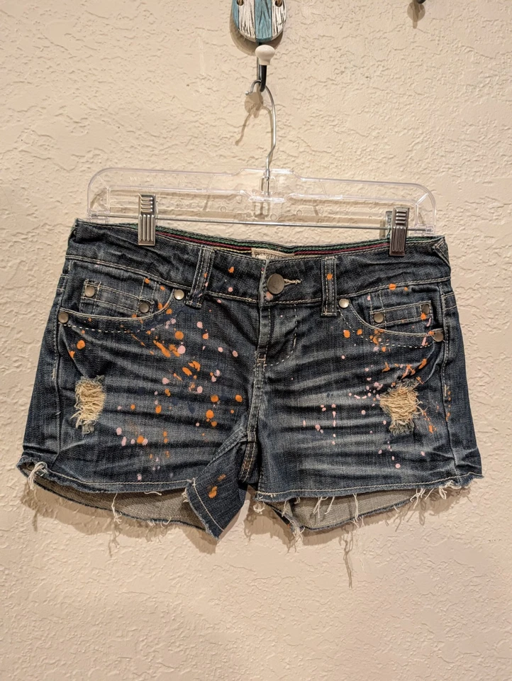 Delia's Denim Short, Very Low,Hip Hugger Y2K Paint Splatter. Sz 5jr Distress. - Image 1 of 4
