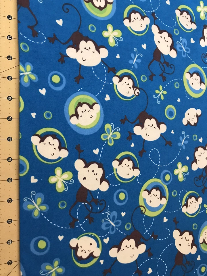 Tossed Monkeys on Blue Flannel Fabric Sold By The Yard #1849 - Image 1 of 1