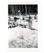 Man covered with sand on beach , woman bathing suits vintage  snapshot Photo