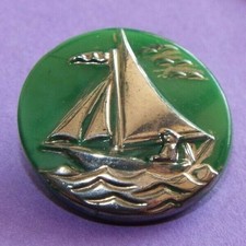 Single old/vintage green glass button depicting a sailing boat in silver lustre