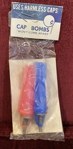 CAP BOMBS! VINTAGE 1970s PLASTIC PAIR MADE IN HONG KONG MINT IN ORIGINAL PACKET! - Picture 1 of 3