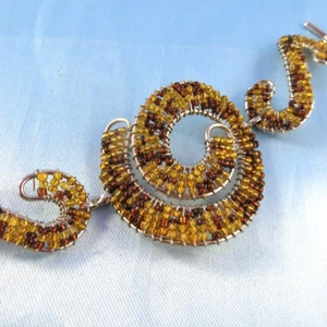 Fun Swirl & Spiral Plastic Beads Through Wires Bracelet Silver-Tone Brown-Yellow - Picture 1 of 9