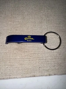 Schlüsselanhänger Corona Metall Flaschenöffner blau mit gelbem Schriftzug neu - Bild 1 von 1