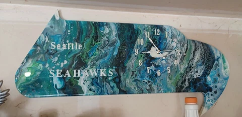 Seahawks logo shaped clock. Hand painted and a Clear coat to protect it Cover