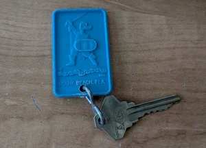Vintage Blue Plastic The Deauville Hotel Miami Beach Florida Postage Keychain - Picture 1 of 3