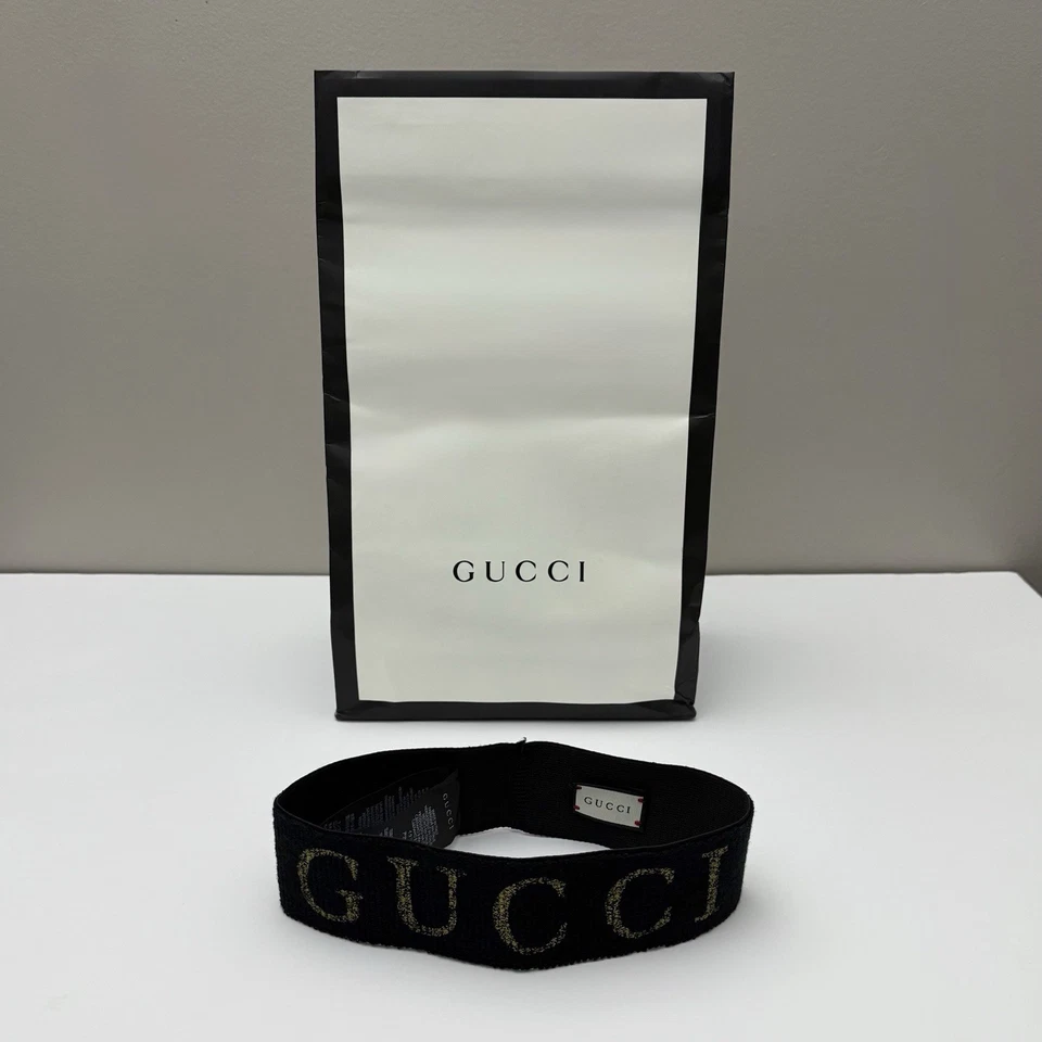 Auténtica diadema Gucci metálica con logotipo de lúrex negra dorada elástica Italia talla única Foto 1 de 4