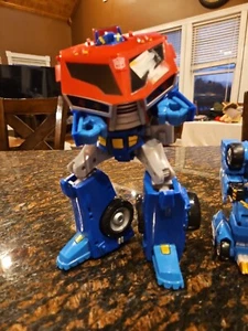 2 Transforming Toys, Optimus Prime Actionfigur Hasbro & Monkart Megaroid - Bild 1 von 9