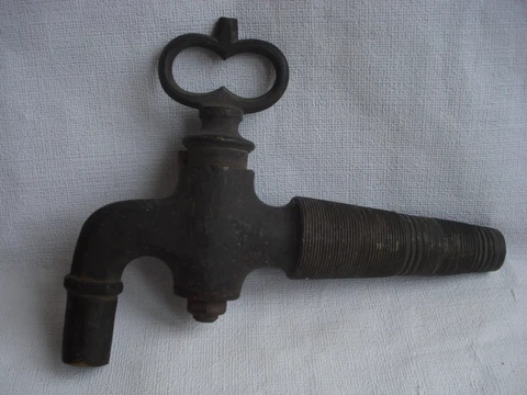 Large tap for a barrel with conical wood carving. Bronze. Vintage Cover