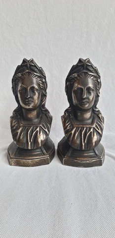 An antique pair of bronzed andiron chenet terminals modelled as  womens heads Cover