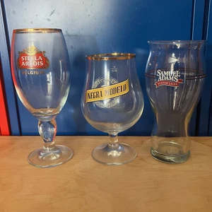LOT OF 3 BEER GLASSES STELLA ARTOIS NEGRA MODELO SAMUEL ADAMS CUPS SNIFTER GOLD - Picture 1 of 5