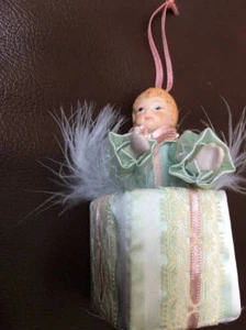 Enesco 1987 Christmas Ornament Child in Present Feathers Ribbon - Picture 1 of 4