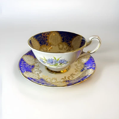 Porcelain tea cup and saucer titled 'Blue and Gold with Cornflowers' by Paragon - Image 1 of 4