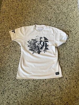 Camisa Rock Rival Color Melocotón Claro Y Negra Talla Grande Cuello Redondo Mangas Cortas Foto 1 de 4