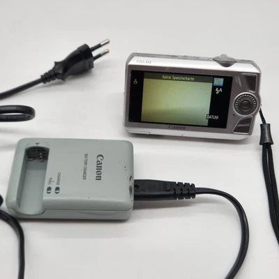 Getestet - Canon IXUS 1000 HS 10,0MP Digital Camera Silver 10x Zoom, Ladegerät - Bild 1 von 4