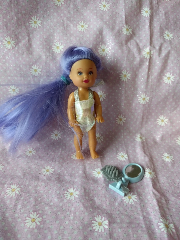 Muñeca pequeña con pelo morado y traje de baño metálico Foto 1 de 1