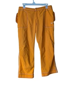 Pantalones deportivos Nike para mujer Capri naranja bolsillos detalle de costuras talla L - Imagen 1 de 11