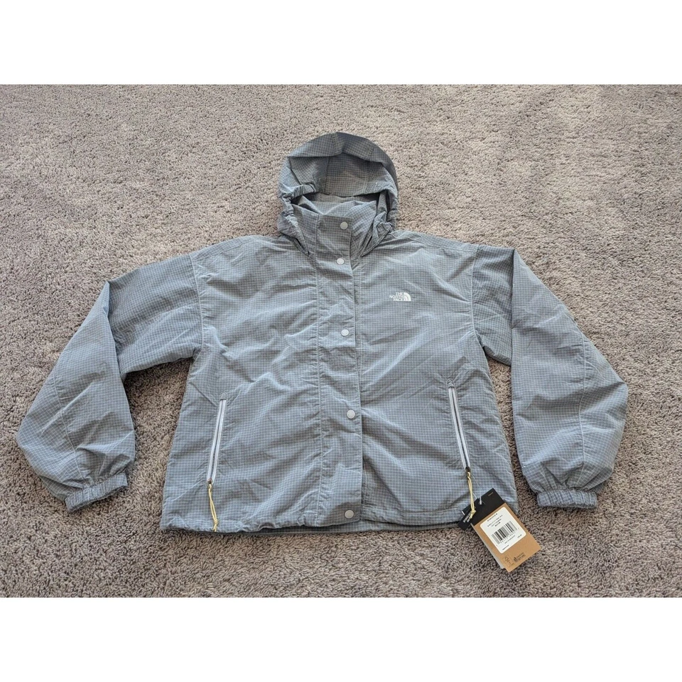 Chaqueta cortavientos The North Face para mujer mediana a presión gris a cuadros con capucha Foto 1 de 4