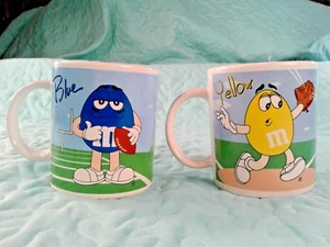 2 M&M MUGS, PLAYING GOLF BASEBALL FOOTBALL RED YELLOW & BLUE M&M'S Lot of 2 - Picture 1 of 12