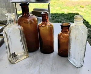 Five vintage medicine bottles four amber and two clear of various sizes, marks - Picture 1 of 22