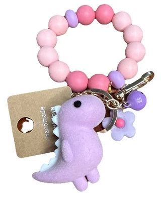 Llavero rosa y lavanda pulsera dinosaurio cuentas de silicona. Rosa T-Rex. Cadena de monedero. Foto 1 de 4