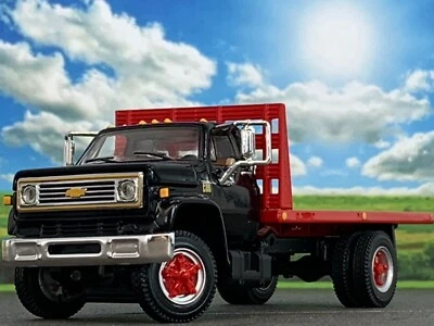 1/64 DCP BLACK/RED CHEVY C65 SINGLE AXLE FLATBED - Image 1 of 4