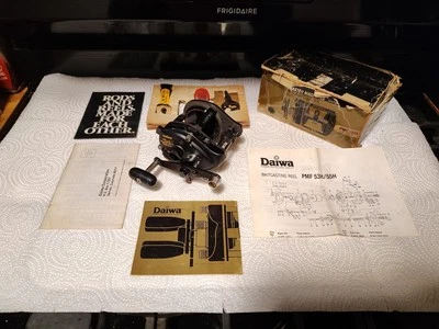 VINTAGE ( Daiwa ) PMF/ 55H Baitcasting Reel with Original Box, Accessories, And - Image 1 of 4