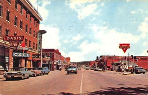Lusk WY Storefronts Oasis Bar Conoco Gas Station Old Cars Postcard - Picture 1 of 2