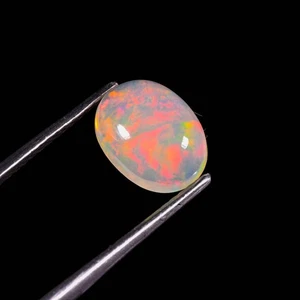 Opale etiope naturale Welo opale di fuoco 10x7x4 mm ovale cabochon pietra preziosa sfusa - Foto 1 di 3