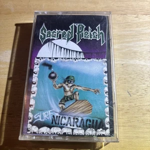 Sacred Reich - Surf Nicaragua - Cassette Tape - Metal Blade - 1988 - Foto 1 di 4
