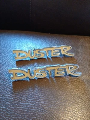 Pair Lot Of 2 VINTAGE 1970S DODGE DUSTER YELLOW METAL EMBLEMS OEM MOPAR - Image 1 of 4