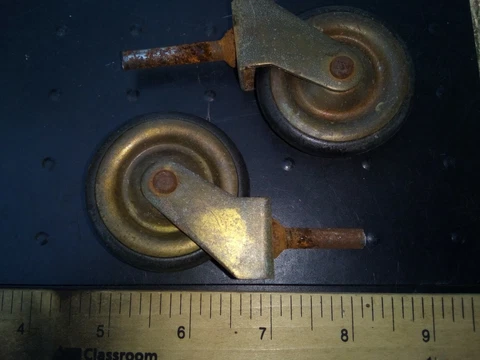 9PP99 PAIR OF ANTIQUE CASTERS: BRASS FRAME & WHEELS, RUBBER TIRES, STEEL PINS Cover