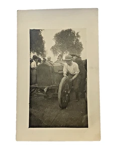 AZO RPPC EARLY AUTOMOBILE ROADSTER BOY INSPECTING A TIRE ONLOOKERS - Picture 1 of 3